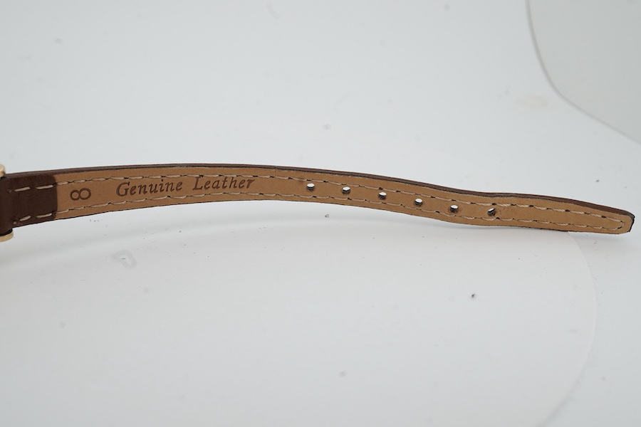 A lady's 9ct gold Jaeger LeCoultre manual wind wrist watch, with baton and quarterly Arabic numerals, cased diameter 20mm, on an associated leather strap, no box or papers.